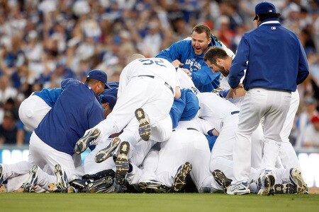 LOS ANGELES, CA - OCTOBER 08:  The Los Angeles Dodgers celebrate after Mark Loretta #5 hit a walk-off RBI to defeat the St. Louis Cardinals in Game Two of the NLDS during the 2009 MLB Playoffs at Dodger Stadium on October 8, 2009 in Los Angeles, California. The Dodgers defeated the Cardinals 3-2 to take a 2-0 series lead.  <br /><br /><span class="help">(Photo by Jeff Gross/Getty Images)</span>