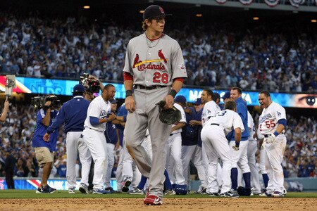 LOS ANGELES, CA - OCTOBER 08:  The Los Angeles Dodgers celebrate after Mark Loretta #5 hit a walk-off RBI to defeat the St. Louis Cardinals as Colby Rasmus #28 walks off the field after Game Two of the NLDS during the 2009 MLB Playoffs at Dodger Stadium on October 8, 2009 in Los Angeles, California. The Dodgers defeated the Cardinals 3-2 to take a 2-0 series lead.  <br /><br /><span class="help">(Photo by Stephen Dunn/Getty Images)</span>