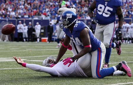 EAST RUTHERFORD, NJ - OCTOBER 11:  Mathias Kiwanuka #94 of the New York Giants forces a fumble against JaMarcus Russell #2 of the Oakland Raiders on October 11, 2009 at Giants Stadium in East Rutherford, New Jersey. The Giants defeated the Raiders 44-7.  <br /><br /><span class="help">(Photo by Jim McIsaac/Getty Images)</span>
