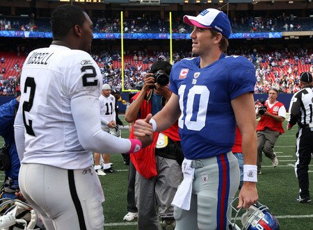 EAST RUTHERFORD, NJ - OCTOBER 11:  Eli Manning #10 of the New York Giants shakes hands with JaMarcus Russell #2 of the Oakland Raiders after their game on October 11, 2009 at Giants Stadium in East Rutherford, New Jersey. The Giants defeated the Raiders 44-7.  <br /><br /><span class="help">(Photo by Jim McIsaac/Getty Images)</span>