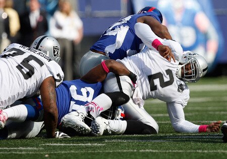 EAST RUTHERFORD, NJ - OCTOBER 11:  JaMarcus Russell #2 of the Oakland Raiders is hit on a play during the game against the New York Giants on October 11, 2009 at Giants Stadium in East Rutherford, New Jersey. <br /><br /><span class="help">(Photo by Jared Wickerham/Getty Images)</span>