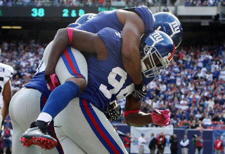 EAST RUTHERFORD, NJ - OCTOBER 11:  Mathias Kiwanuka #94 of the New York Giants celebrates after forcing a fumble against the Oakland Raiders with teammate Osi Umenyiora #72 on October 11, 2009 at Giants Stadium in East Rutherford, New Jersey. The Giants defeated the Raiders 44-7.  <br /><br /><span class="help">(Photo by Jim McIsaac/Getty Images)</span>