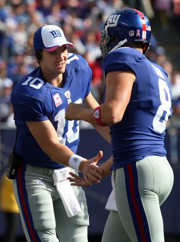 EAST RUTHERFORD, NJ - OCTOBER 11:  Eli Manning #10 of the New York Giants congratulates teammate David Carr #8 after Carr's touchdown run against the Oakland Raiders on October 11, 2009 at Giants Stadium in East Rutherford, New Jersey. The Giants defeated the Raiders 44-7.  <br /><br /><span class="help">(Photo by Jim McIsaac/Getty Images)</span>