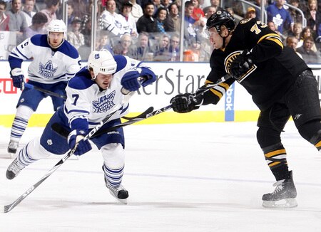 TORONTO - DECEMBER 19:  Ian White #7 gets hit by the follow through of Michael Ryder #73 of the Toronto Maple Leafs of the Boston Bruins during game action December 19, 2009 at the Air Canada Centre in Toronto, Ontario, Canada. <br /><br /><span class="help">(Photo by Abelimages/Getty Images)</span>