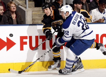 TORONTO - DECEMBER 19:  Francois Beauchemin #22 of the Toronto Maple Leafs forces Byron Bitz #61 of the Boston Bruins to shoot during game action December 19, 2009 at the Air Canada Centre in Toronto, Ontario, Canada. <br /><br /><span class="help">(Photo by Abelimages/Getty Images)</span>