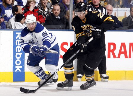 TORONTO - DECEMBER 19:  Francois Beauchemin #22 of the Toronto Maple Leafs battles for the puck with Blake Wheeler #26 of the Boston Bruins during game action December 19, 2009 at the Air Canada Centre in Toronto, Ontario, Canada. <br /><br /><span class="help">(Photo by Abelimages/Getty Images)</span>