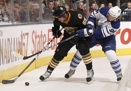 TORONTO - DECEMBER 19:  Mikhail Grabovski #84 of the Toronto Maple Leafs battles for the puck with Johnny Boychuk #55 of the Boston Bruins during game action December 19, 2009 at the Air Canada Centre in Toronto, Ontario, Canada. <br /><br /><span class="help">(Photo by Abelimages/Getty Images)</span>