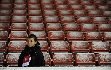 STOKE ON TRENT, ENGLAND - JANUARY 05: A young Stoke City fan braves the cold to see his team during the Barclays Premier League match between Stoke City and Fulham at The Britannia Stadium on January 5, 2010 in Stoke on Trent, England.  <br /><br /><span class="help">(Photo by Laurence Griffiths/Getty Images)</span>