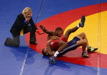 SINGAPORE - AUGUST 15:  Shadybek Sulaimanov of Kyrgyzstan competes against Johan Rodriguez Banguela of Cuba in the Men's Greco Roman 50kg Wrestling competition on day one of the Youth Olympics at the International Convention Centre on August 15, 2010 in Singapore.  <br /><br /><span class="help">(Photo by Mark Dadswell/Getty Images)</span>