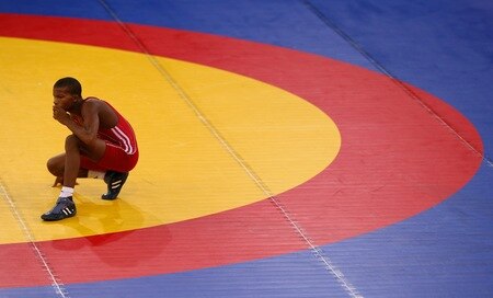SINGAPORE - AUGUST 15:   Johan Rodriguez Banguela of Cuba is dejected after losing to Shadybek Sulaimanov of Kyrgyzstan in the Men's Greco Roman 50kg Wrestling competition on day one of the Youth Olympics at the International Convention Centre on August 15, 2010 in Singapore.  <br /><br /><span class="help">(Photo by Mark Dadswell/Getty Images)</span>