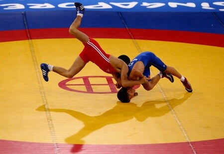 SINGAPORE - AUGUST 15:  Elman Mukhtarov of Azerbaijan competes against Nurbek Hakkulov of Uzbekistan in the final of the Men's Greco Roman 50kg Wrestling competition on day one of the Youth Olympics at the International Convention Centre on August 15, 2010 in Singapore.  <br /><br /><span class="help">(Photo by Mark Dadswell/Getty Images)</span>