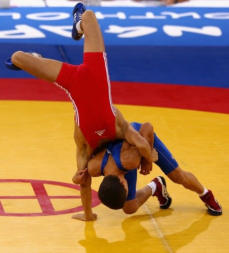 SINGAPORE - AUGUST 15:  Elman Mukhtarov of Azerbaijan competes against Nurbek Hakkulov of Uzbekistan in the final of the Men's Greco Roman 50kg Wrestling competition on day one of the Youth Olympics at the International Convention Centre on August 15, 2010 in Singapore.  <br /><br /><span class="help">(Photo by Mark Dadswell/Getty Images)</span>