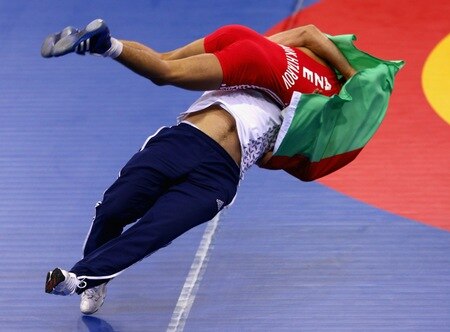 SINGAPORE - AUGUST 15:  Elman Mukhtarov of Azerbaijan celebrates winning the Gold medal with his coach Abdulov after defeating Nurbek Hakkulov of Uzbekistan in the Men's Greco Roman 50kg Wrestling competition on day one of the Youth Olympics at the International Convention Centre on August 15, 2010 in Singapore.  <br /><br /><span class="help">(Photo by Mark Dadswell/Getty Images)</span>