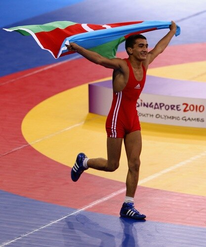 SINGAPORE - AUGUST 15:  Elman Mukhtarov of Azerbaijan celebrates winning the Gold medal  after defeating Nurbek Hakkulov of Uzbekistan in the Men's Greco Roman 50kg Wrestling competition on day one of the Youth Olympics at the International Convention Centre on August 15, 2010 in Singapore.  <br /><br /><span class="help">(Photo by Mark Dadswell/Getty Images)</span>