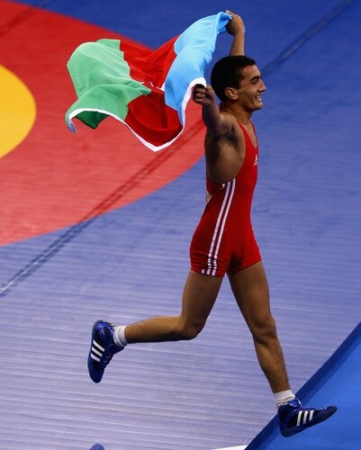 SINGAPORE - AUGUST 15:  Elman Mukhtarov of Azerbaijan celebrates winning the Gold medal  after defeating Nurbek Hakkulov of Uzbekistan in the Men's Greco Roman 50kg Wrestling competition on day one of the Youth Olympics at the International Convention Centre on August 15, 2010 in Singapore.  <br /><br /><span class="help">(Photo by Mark Dadswell/Getty Images)</span>