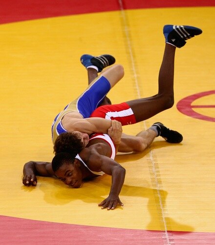 SINGAPORE - AUGUST 15:  Artur Suleymanov of the Russian Federation competes against Jason Afrikaner of Namibia in the Men's Greco Roman 58kg Wrestling competition on day one of the Youth Olympics at the International Convention Centre on August 15, 2010 in Singapore.  <br /><br /><span class="help">(Photo by Mark Dadswell/Getty Images)</span>