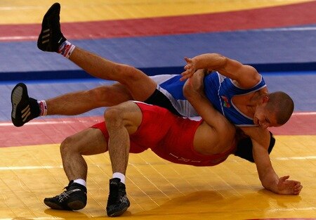 SINGAPORE - AUGUST 15:  Yousef Ghaderian of Iran competes against Allaksandr Nedashkouski of Belarus  in the Men's Greco Roman 69kg Wrestling competition on day one of the Youth Olympics at the International Convention Centre on August 15, 2010 in Singapore.  <br /><br /><span class="help">(Photo by Mark Dadswell/Getty Images)</span>