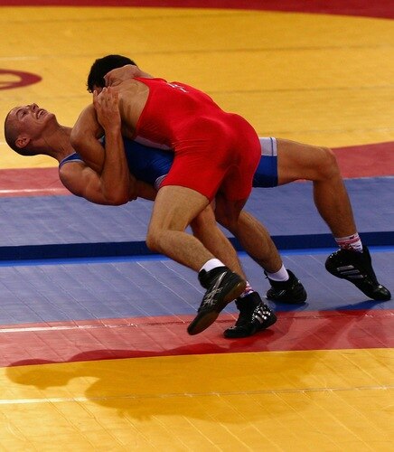 SINGAPORE - AUGUST 15:  Yousef Ghaderian of Iran competes against Allaksandr Nedashkouski of Belarus  in the Men's Greco Roman 69kg Wrestling competition on day one of the Youth Olympics at the International Convention Centre on August 15, 2010 in Singapore.  <br /><br /><span class="help">(Photo by Mark Dadswell/Getty Images)</span>