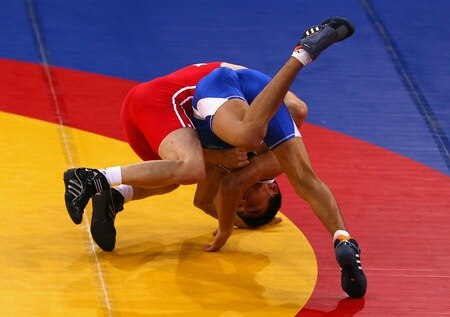 SINGAPORE - AUGUST 15:  Musa Gedik of Turkey competes against Zhanibek Kandybayev of Kazakhstan  in the final of the Men's Greco Roman 69kg Wrestling competition on day one of the Youth Olympics at the International Convention Centre on August 15, 2010 in Singapore.  <br /><br /><span class="help">(Photo by Mark Dadswell/Getty Images)</span>