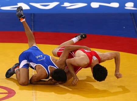 SINGAPORE - AUGUST 15:  Musa Gedik of Turkey competes against Zhanibek Kandybayev of Kazakhstan  in the final of the Men's Greco Roman 69kg Wrestling competition on day one of the Youth Olympics at the International Convention Centre on August 15, 2010 in Singapore.  <br /><br /><span class="help">(Photo by Mark Dadswell/Getty Images)</span>