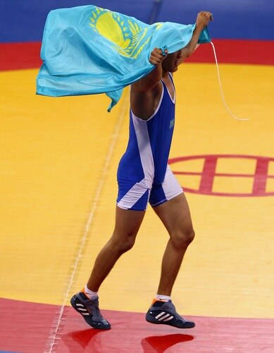 SINGAPORE - AUGUST 15:   Zhanibek Kandybayev of Kazakhstan celebrates winning the final of the Men's Greco Roman 69kg Wrestling competition on day one of the Youth Olympics at the International Convention Centre on August 15, 2010 in Singapore.  <br /><br /><span class="help">(Photo by Mark Dadswell/Getty Images)</span>