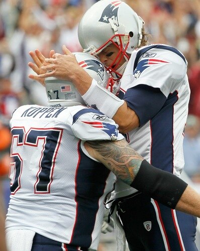 FOXBORO, MA - SEPTEMBER 12: Quarterback Tom Brady #12 of the New England Patriots celebrates with Dan Koppen #67 reacts after teammate Wes Welker #83 scored a touchdown in the first quarter during the NFL season opener against the Cincinnati Bengals at Gillette Stadium on September 12, 2010 in Foxboro, Massachusetts. <br /><br /><span class="help">(Photo by Jim Rogash/Getty Images)</span>