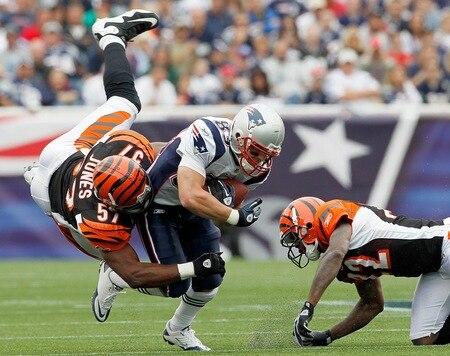 FOXBORO, MA - SEPTEMBER 12:  Wes Welker #83 of the New England Patriots gains yardage despite the defense of Dhani Jones #57 and Cedric Benson #32 of the Cincinnati Bengals during during the NFL season opener at Gillette Stadium on September 12, 2010 in Foxboro, Massachusetts. <br /><br /><span class="help">(Photo by Jim Rogash/Getty Images)</span>