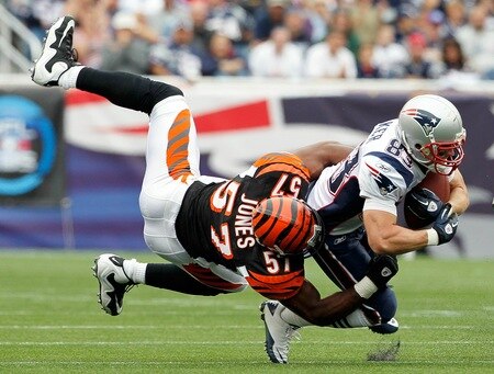 FOXBORO, MA - SEPTEMBER 12:  Wes Welker #83 of the New England Patriots gains yardage despite the defense of Dhani Jones #57 of the Cincinnati Bengals during during the NFL season opener at Gillette Stadium on September 12, 2010 in Foxboro, Massachusetts. <br /><br /><span class="help">(Photo by Jim Rogash/Getty Images)</span>