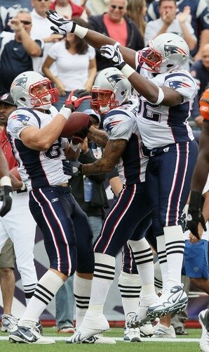 FOXBORO, MA - SEPTEMBER 12:  Rob Gronkowski #87 of the New England Patriots celebrates his touchdown wit teammates Alge Crumpler #82 and Aaron Hernandez #85 in the fourth quarter against the Cincinnati Bengals during the NFL season opener on September 12, 2010 at Gillette Stadium in Foxboro, Massachusetts. The Patriots defeated the Bengals 38-24.  <br /><br /><span class="help">(Photo by Elsa/Getty Images)</span>