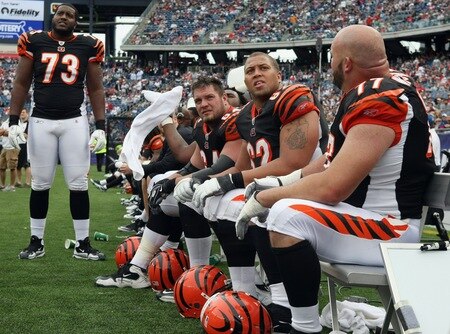 FOXBORO, MA - SEPTEMBER 12:  Anthony Collins #73 of the Cincinnati Bengals and the rest of the bench watch the New England Patriots score another touchdown during the NFL season opener on September 12, 2010 at Gillette Stadium in Foxboro, Massachusetts. The Patriots defeated the Bengals 38-24.  <br /><br /><span class="help">(Photo by Elsa/Getty Images)</span>