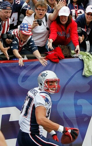 FOXBORO, MA - SEPTEMBER 12:  Rob Gronkowski #87 of the New England Patriots celebrates his touchdown catch as fans cheer in the second half against the Cincinnati Bengals during during the NFL season opener at Gillette Stadium on September 12, 2010 in Foxboro, Massachusetts. The Patriots won 38-24. <br /><br /><span class="help">(Photo by Jim Rogash/Getty Images)</span>