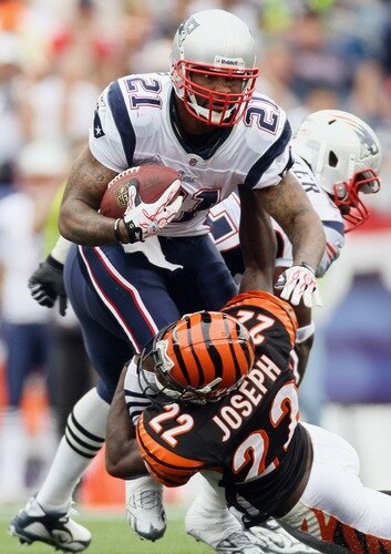 FOXBORO, MA - SEPTEMBER 12:  Fred Taylor #21 of the New England Patriots is tackled by Johnathan Joseph #22 of the Cincinnati Bengals during the NFL season opener on September 12, 2010 at Gillette Stadium in Foxboro, Massachusetts. The Patriots defeated the Bengals 38-24.  <br /><br /><span class="help">(Photo by Elsa/Getty Images)</span>
