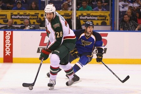 ST. LOUIS - SEPTEMBER 24: Matt Kassian #28 of the Minnesota Wild moves the puck up the ice against Roman Polak #46 of the St. Louis Blues during a pre-season game at the Scottrade Center on September 24, 2010 in St. Louis, Missouri.  <br /><br /><span class="help">(Photo by Dilip Vishwanat/Getty Images)</span>