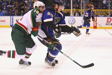 ST. LOUIS - SEPTEMBER 24: Ian Cole #23 of the St. Louis Blues races to the puck against Colton Gillies #18 of the Minnesota Wild during a pre-season game at the Scottrade Center on September 24, 2010 in St. Louis, Missouri.  <br /><br /><span class="help">(Photo by Dilip Vishwanat/Getty Images)</span>
