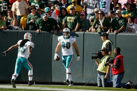 GREEN BAY, WI - OCTOBER 17: Anthony Fasano #80 of the Miami Dolphins celebrates a touchdown against the Green Bay Packers at Lambeau Field on October 17, 2010 in Green Bay, Wisconsin. The Dolphins defeated the Packers 23-20 in overtime. <br /><br /><span class="help">(Photo by Scott Boehm/Getty Images)</span>