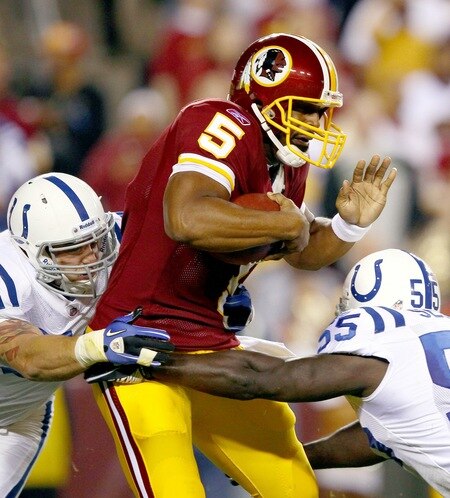 LANDOVER, MD - OCTOBER 17: Quarterback Donovan McNabb #5 of the Washington Redskins is sacked by Clint Session #55 and Pat Angerer #51 of the Indianapolis Colts in first quarter action at FedExField on October 17, 2010 in Landover, Maryland.  <br /><br /><span class="help">(Photo by Win McNamee/Getty Images)</span>
