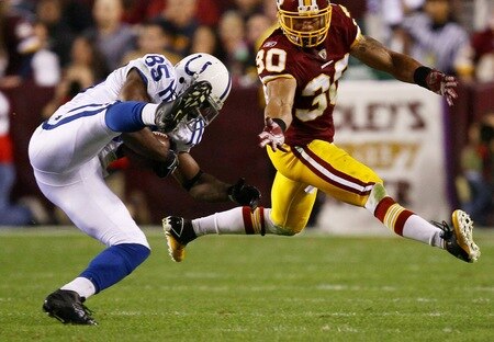 LANDOVER, MD - OCTOBER 17:  Reggie Wayne #85 makes a catch against LaRon Landry #30 of the Washington Redskins in second quarter action at FedExField on October 17, 2010 in Landover, Maryland.  <br /><br /><span class="help">(Photo by Win McNamee/Getty Images)</span>