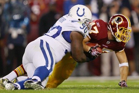 LANDOVER, MD - OCTOBER 17: Tight end Chris Cooley #47 of the Washington Redskins is tackled by Dan Muir #90 of the Indianapolis Colts at FedExField on October 17, 2010 in Landover, Maryland. The Colts won the game 27-24.   <br /><br /><span class="help">(Photo by Win McNamee/Getty Images)</span>