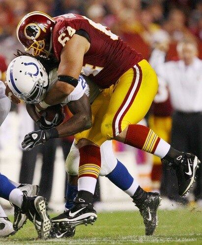LANDOVER, MD - OCTOBER 17:  Running back Joseph Addai #29 of the Indianapolis Colts is tackled by Kedric Golston #64 of the Washington Redskins at FedEx Field on October 17, 2010 in Landover, Maryland. The Colts won the game 27-24.  <br /><br /><span class="help">(Photo by Win McNamee/Getty Images)</span>