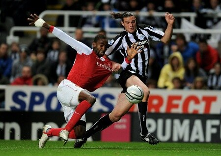 NEWCASTLE UPON TYNE, ENGLAND - OCTOBER 27:  Andy Carroll of Newcastle United tangles with Johan Djourou of Arsenal during the Carling Cup Fourth Round match between Newcastle United and Arsenal at St James' Park on October 27, 2010 in Newcastle, England.  <br /><br /><span class="help">(Photo by Michael Regan/Getty Images)</span>
