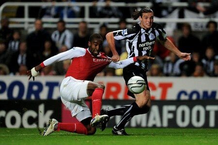 NEWCASTLE UPON TYNE, ENGLAND - OCTOBER 27:  Andy Carroll of Newcastle United tangles with Johan Djourou of Arsenal during the Carling Cup Fourth Round match between Newcastle United and Arsenal at St James' Park on October 27, 2010 in Newcastle, England.  <br /><br /><span class="help">(Photo by Michael Regan/Getty Images)</span>