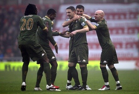 STOKE ON TRENT, ENGLAND - DECEMBER 28:  Chris Baird of Fulham celebrates with team mates after scoring his second goal from a free kick during the Barclays Premier League match between Stoke City and Fulham at Britannia Stadium on December 28, 2010 in Stoke on Trent, England.  <br /><br /><span class="help">(Photo by Clive Brunskill/Getty Images)</span>