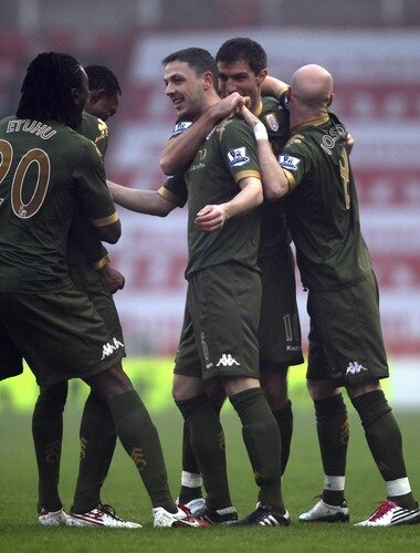 STOKE ON TRENT, ENGLAND - DECEMBER 28:  Chris Baird of Fulham celebrates with team mates after scoring his second goal from a free kick during the Barclays Premier League match between Stoke City and Fulham at Britannia Stadium on December 28, 2010 in Stoke on Trent, England.  <br /><br /><span class="help">(Photo by Clive Brunskill/Getty Images)</span>