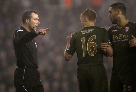 STOKE ON TRENT, ENGLAND - DECEMBER 28: Referee Mr K. Friend makes his point to Damien Duff and Clint Dempsey of Fulham during the Barclays Premier League match between Stoke City and Fulham at Britannia Stadium on December 28, 2010 in Stoke on Trent, England.  <br /><br /><span class="help">(Photo by Clive Brunskill/Getty Images)</span>