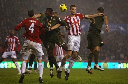 STOKE ON TRENT, ENGLAND - DECEMBER 28:  Ryan Shawcross of Stoke City in action with John Paintsil of Fulham during the Barclays Premier League match between Stoke City and Fulham at Britannia Stadium on December 28, 2010 in Stoke on Trent, England.  <br /><br /><span class="help">(Photo by Clive Brunskill/Getty Images)</span>