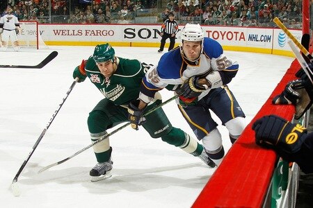 SAINT PAUL, MN - FEBRUARY 12: Eric Nystrom #23 of the Minnesota Wild and Cam Janssen #55 of the St. Louis Blues skate to the puck along the boards during the game at Xcel Energy Center on February 12, 2011 in Saint Paul, Minnesota.  <br /><br /><span class="help">(Photo by Bruce Kluckhohn/NHLI via Getty Images)</span>