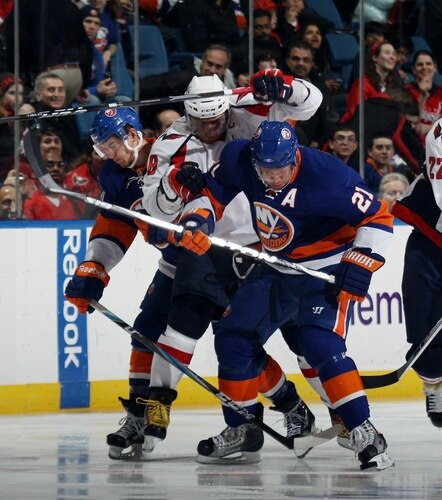 UNIONDALE, NY - FEBRUARY 26: Alex Ovechkin #8 of the Washington Capitals tries to get past Michael Grabner #40 and Kyle Okposo #21 of the New York Islanders at the Nassau Coliseum on February 26, 2011 in Uniondale, New York.  <br /><br /><span class="help">(Photo by Bruce Bennett/Getty Images)</span>