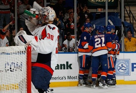 UNIONDALE, NY - FEBRUARY 26:  Kyle Okposo #21 of the New York Islanders celebrates his first period goal with teammates as goaltender Michal Neuvirth #30 of the Washington Capitals gets a drink on February 26, 2011 at Nassau Coliseum in Uniondale, New York.  <br /><br /><span class="help">(Photo by Mike Stobe/NHLI via Getty Images)</span>