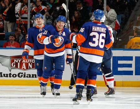 UNIONDALE, NY - FEBRUARY 26:  Travis Hamonic #36 of the New York Islanders celebrates his second period goal with teammates Kyle Okposo #21 and Michael Grabner #40 in a game against the Washington Capitals on February 26, 2011 at Nassau Coliseum in Uniondale, New York.  <br /><br /><span class="help">(Photo by Mike Stobe/NHLI via Getty Images)</span>
