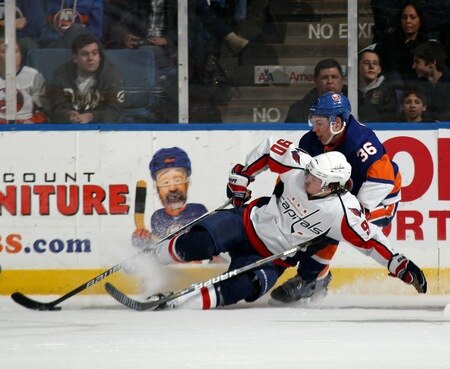 UNIONDALE, NY - FEBRUARY 26: Marcus Johansson #90 of the Washington Capitals is tripped up by Travis Hamonic #36 of the New York Islanders at the Nassau Coliseum on February 26, 2011 in Uniondale, New York.  <br /><br /><span class="help">(Photo by Bruce Bennett/Getty Images)</span>